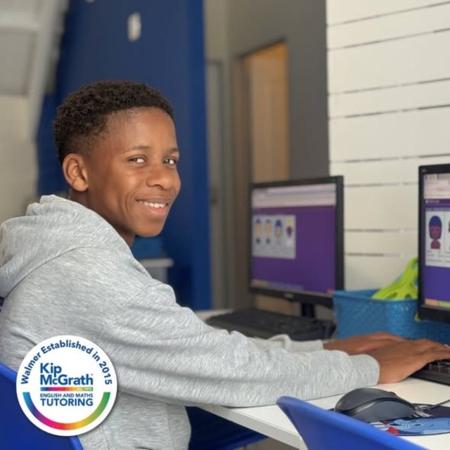 A smiling learner at the computer – Kip McGrath Walmer Facebook post