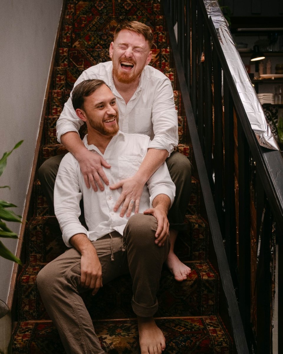 Zane and Christiaan of Meerkat Mango laughing together on a staircase